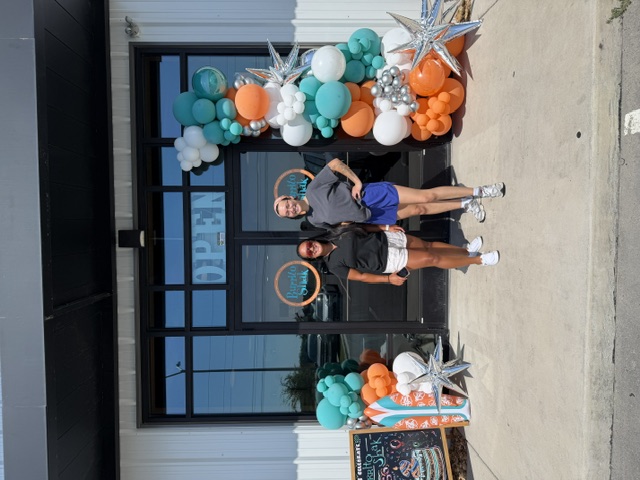 Orange and teal balloon columns for a business grand opening